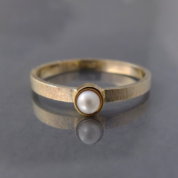 minimalistyczny złoty pierścionek z perłą z białego złota